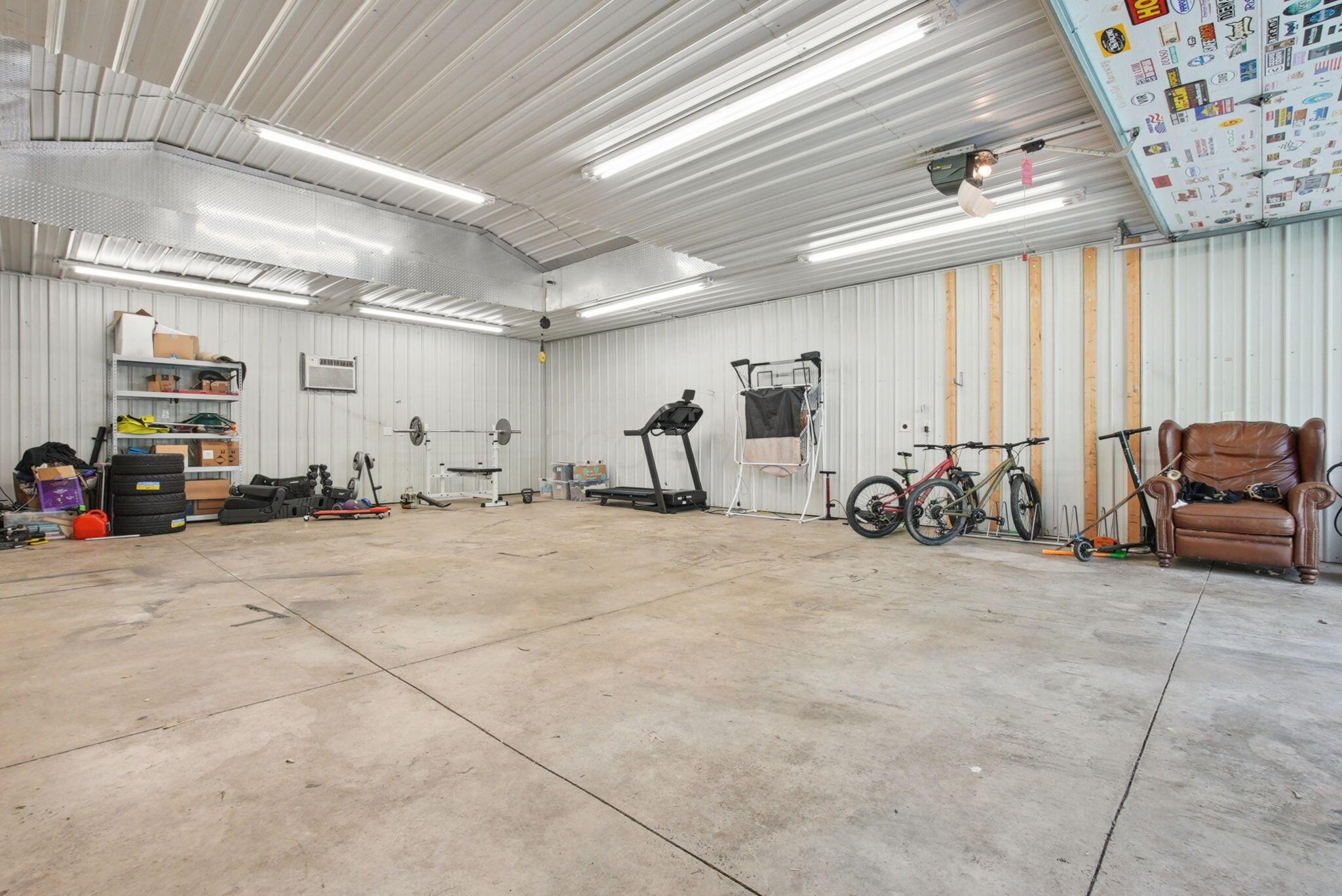 9435 Concord Road Powell, OH 43065 - Photo 52 of 77 Spacious heated garage featuring concrete flooring, corrugated metal walls