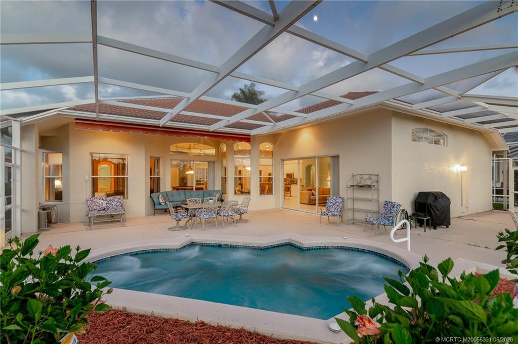 2216 Southeast Stonehaven Road Port St. Lucie, FL 34952 - Photo 5 of 67 a view of a porch with chairs and potted plants