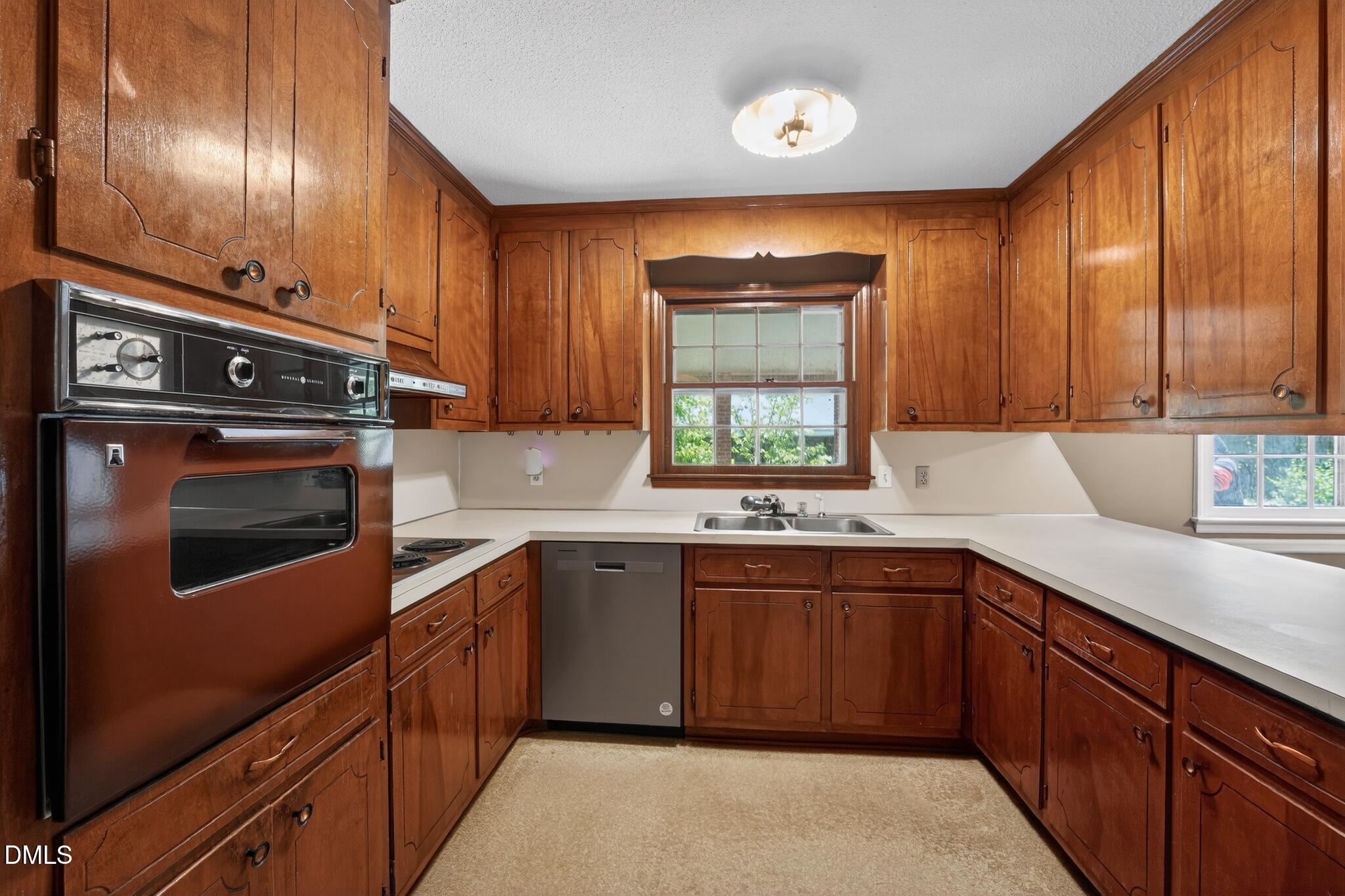1034 Jerome Road Durham, NC 27713 - Photo 15 of 35 a kitchen with stainless steel appliances granite countertop wooden cabinets a sink and a stove