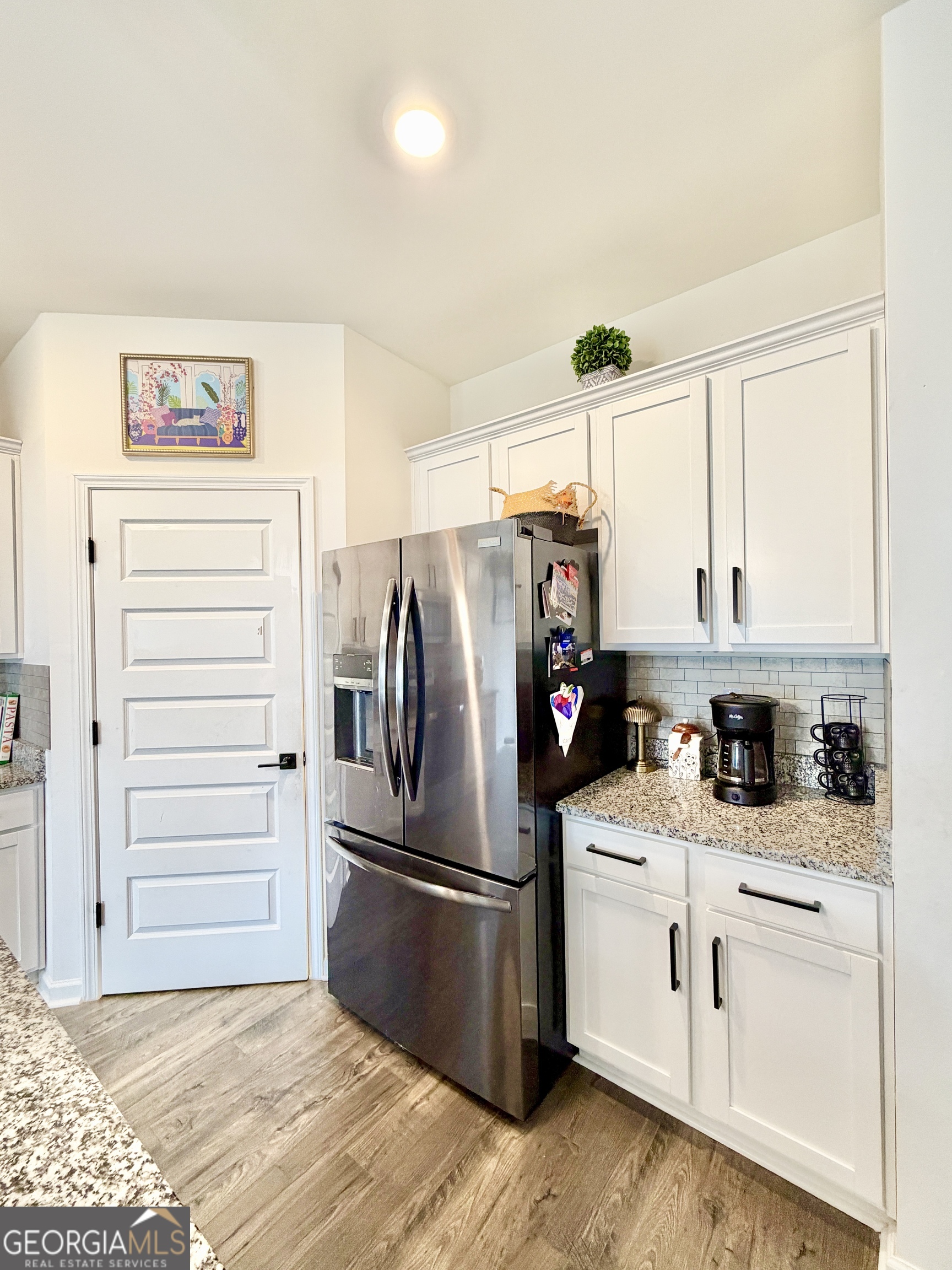 219 Barnyard Way Perry, GA 31069 - Photo 10 of 44 a kitchen with white cabinets and white appliances