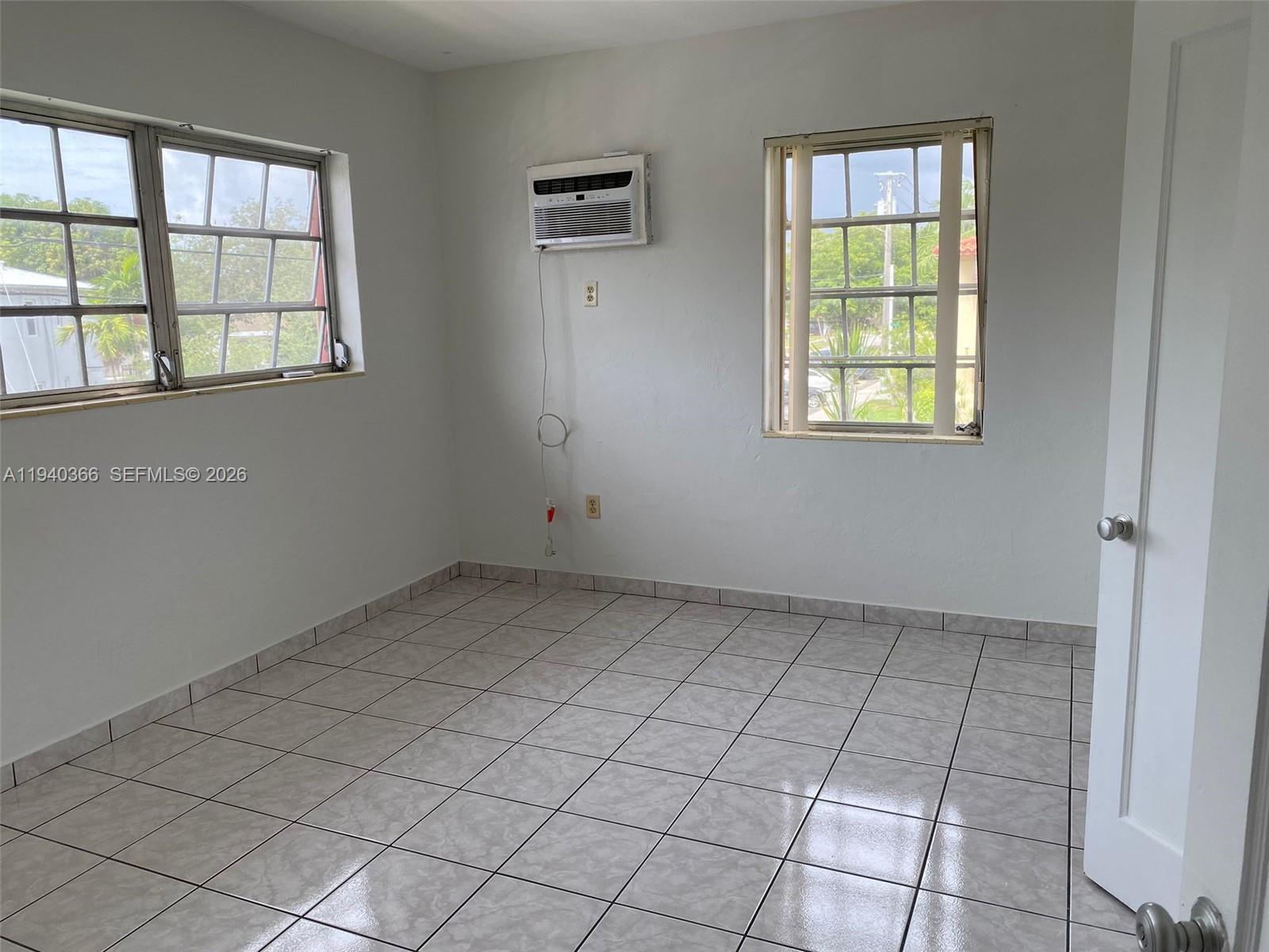 631 Southwest 11th Street, Unit 3W Miami, FL 33129 - Photo 3 of 3 an empty room with windows