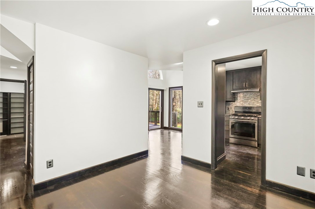 178 Brook Lane Boone, NC 28607 - Photo 12 of 48 a view of a hallway with wooden floor and a living room
