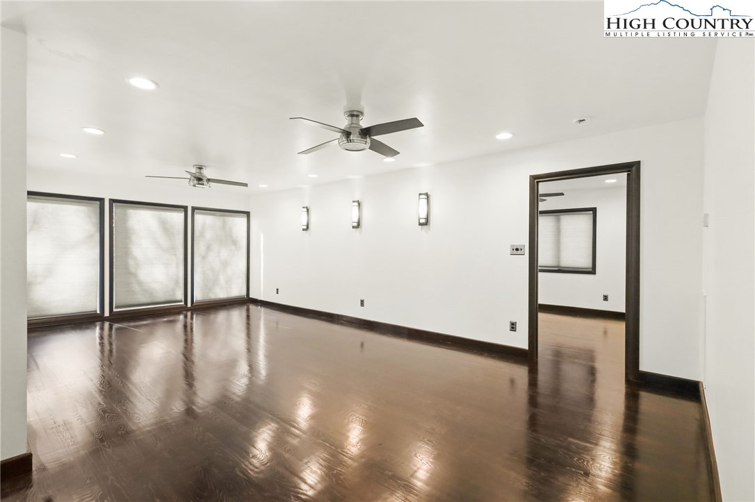 178 Brook Lane Boone, NC 28607 - Photo 13 of 48 a view of an empty room with wooden floor and a ceiling fan