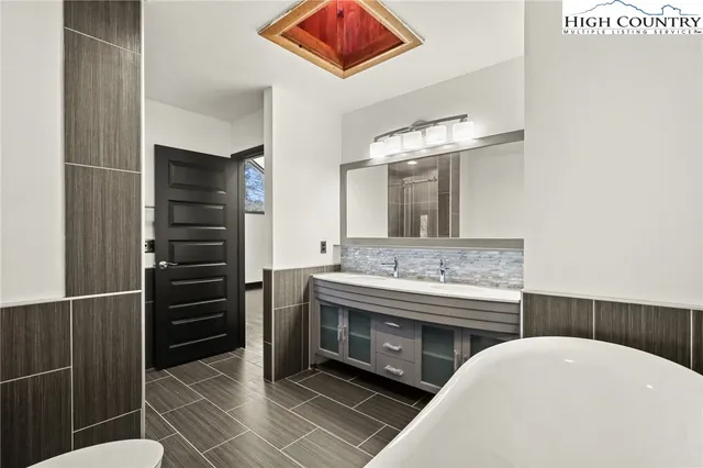 a white toilet sitting next to a bathroom sink