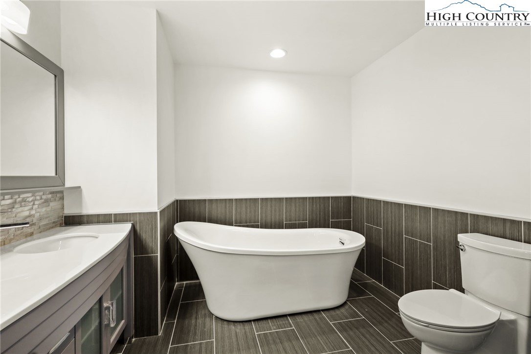 178 Brook Lane Boone, NC 28607 - Photo 34 of 48 a white toilet sitting next to a bathroom sink