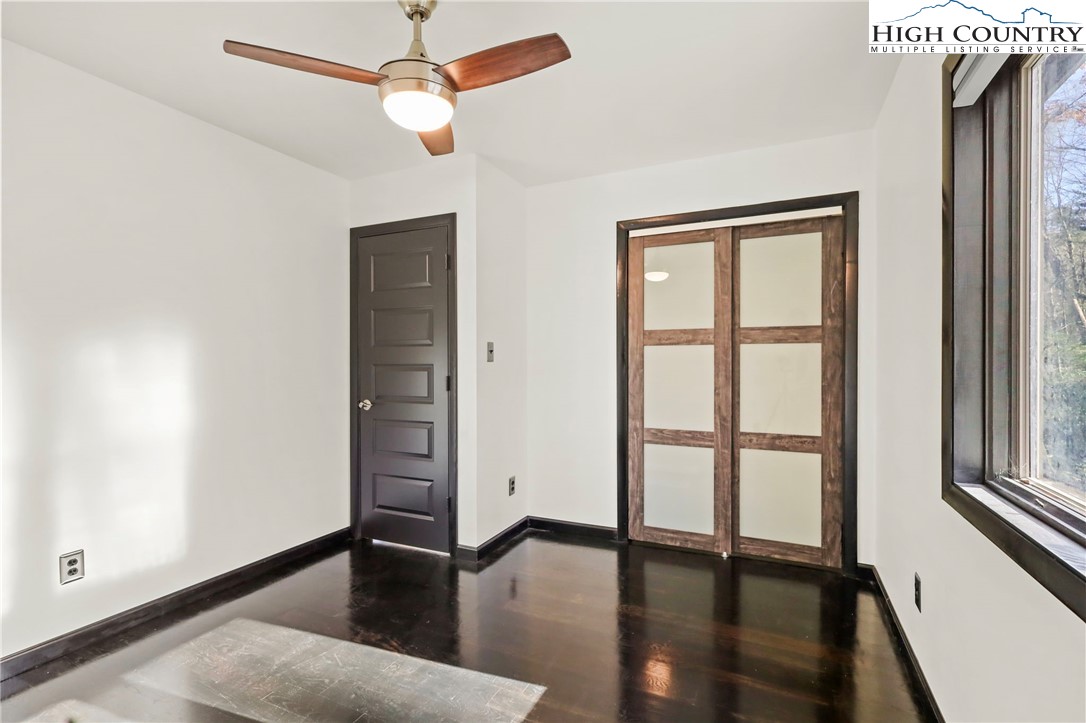 178 Brook Lane Boone, NC 28607 - Photo 36 of 48 an empty room with wooden floor closet and windows