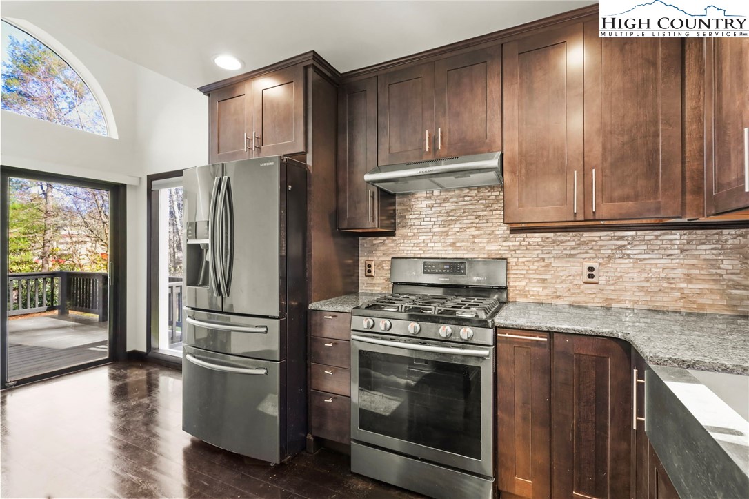 178 Brook Lane Boone, NC 28607 - Photo 6 of 48 a kitchen with granite countertop wooden cabinets and stainless steel appliances