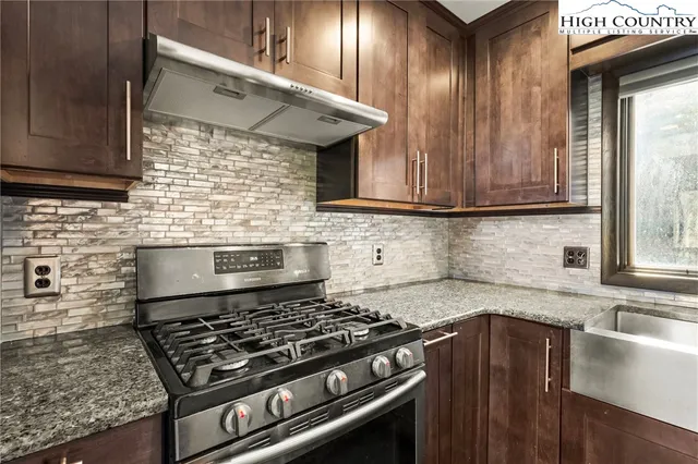 a kitchen with granite countertop a sink and a window