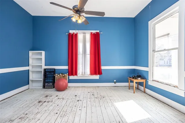 a bed room with a bed and a chair