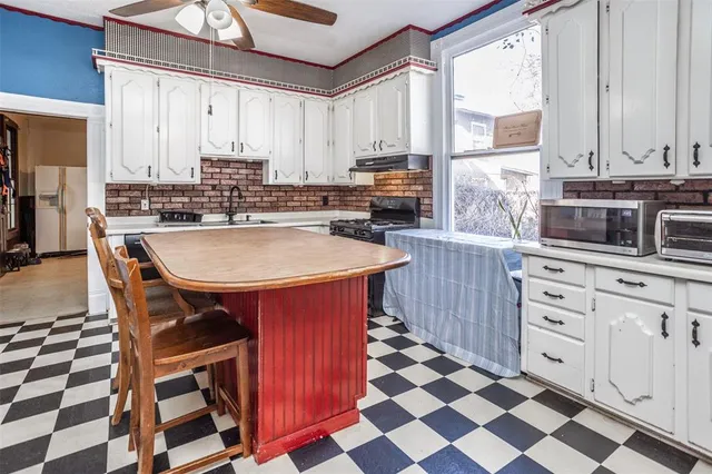 a kitchen with stainless steel appliances granite countertop a stove a sink a microwave and dining table