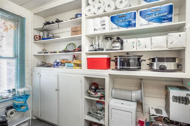 a dining room with wooden floor a chandelier a wooden table and chairs