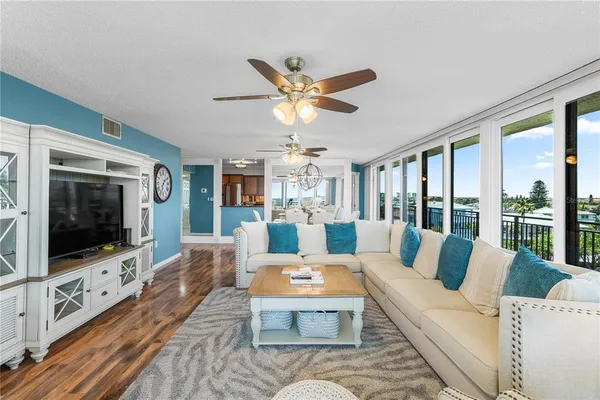 a living room with furniture and two large window