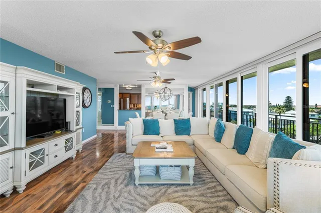 a living room with furniture and two large window