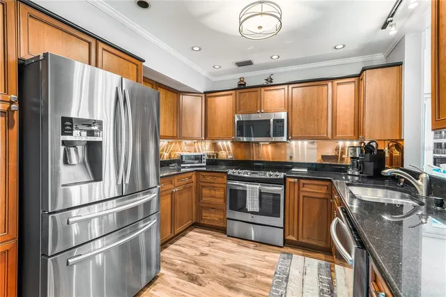 a bedroom with a large bed and a flat tv screen on dresser
