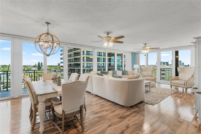 a living room with couches a dining table and chairs