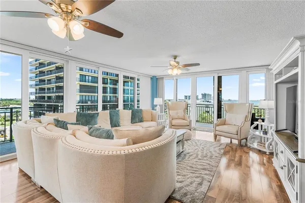 a living room with furniture fireplace and a large window