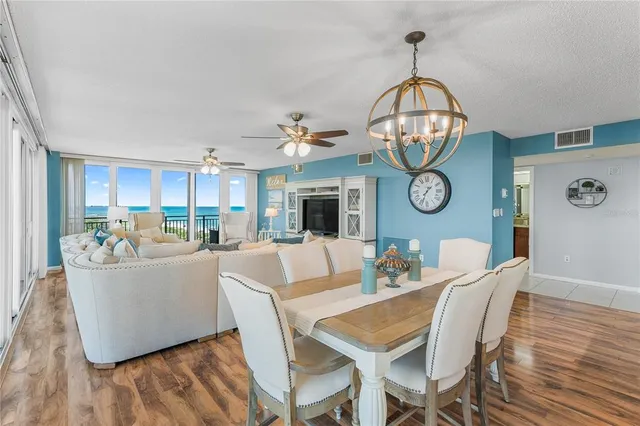 a living room with furniture flat screen tv and wooden floor