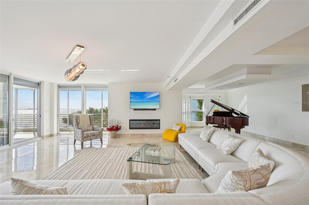 2450 Harbourside Drive, Unit 244 Longboat Key, FL 34228 - Photo 11 of 46 a living room with furniture and a flat screen tv