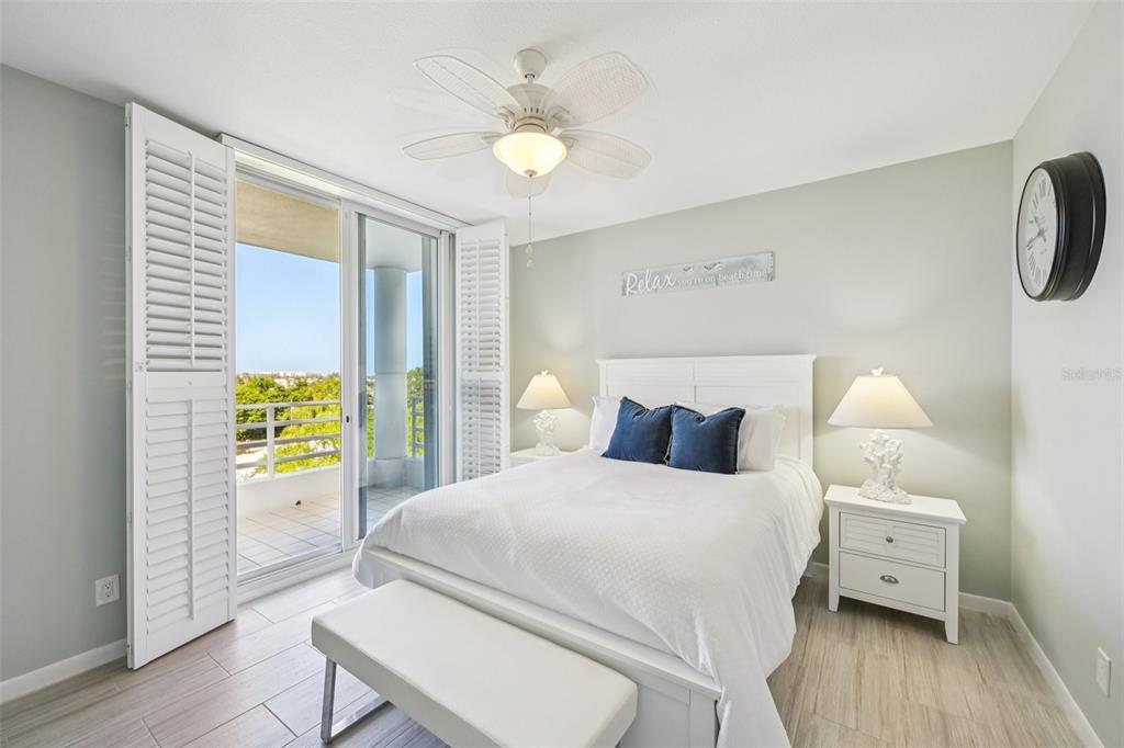 2450 Harbourside Drive, Unit 244 Longboat Key, FL 34228 - Photo 14 of 46 a bedroom with a bed and a chandelier