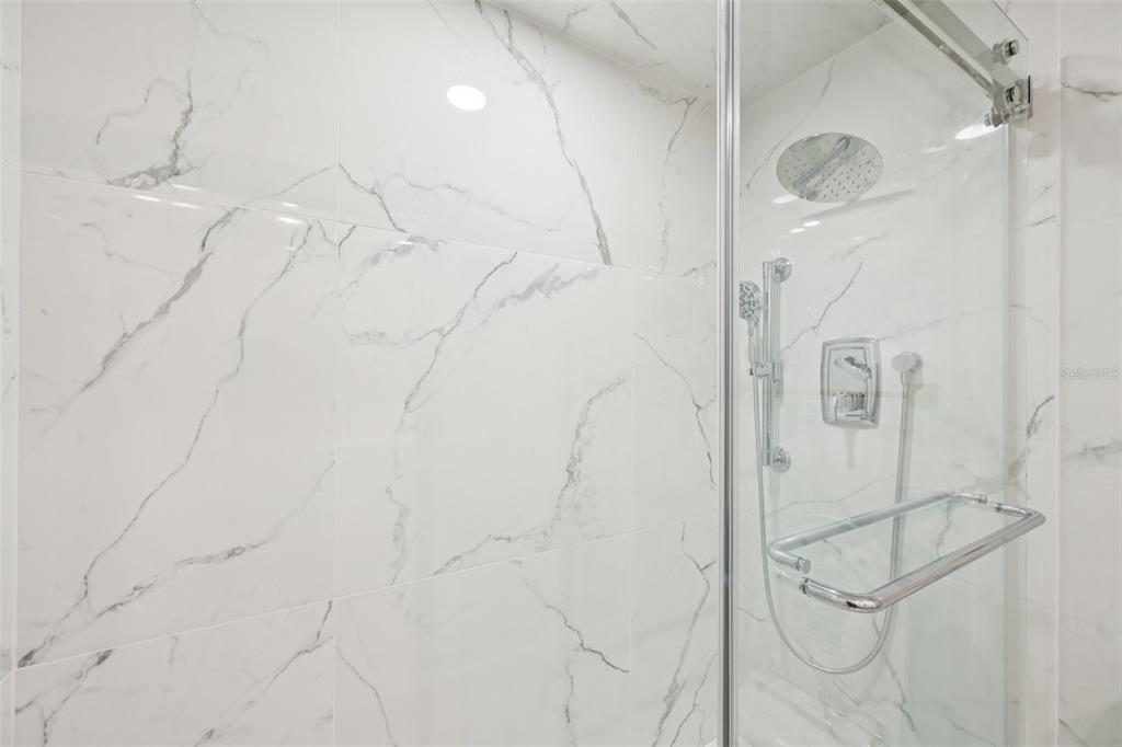 2450 Harbourside Drive, Unit 244 Longboat Key, FL 34228 - Photo 15 of 46 a bathroom with a glass shower door