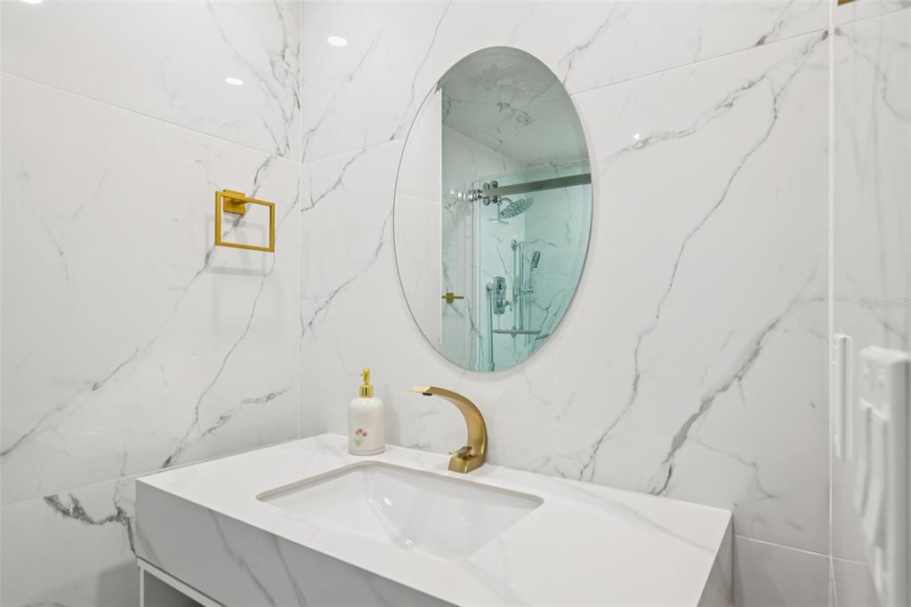 2450 Harbourside Drive, Unit 244 Longboat Key, FL 34228 - Photo 16 of 46 a bathroom with a sink and a mirror