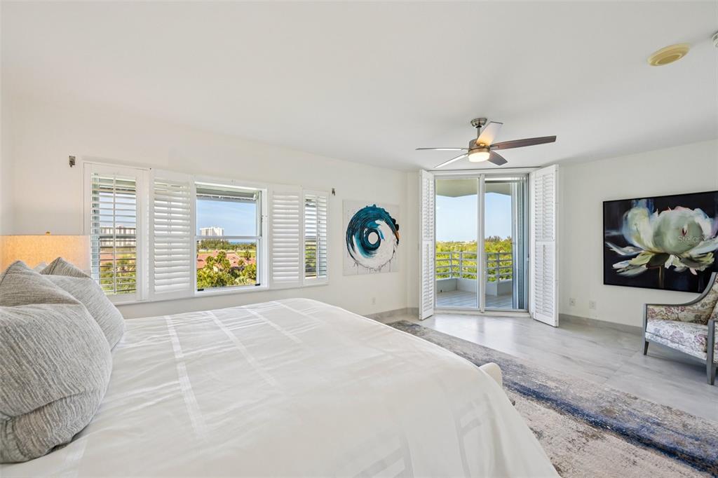 2450 Harbourside Drive, Unit 244 Longboat Key, FL 34228 - Photo 18 of 46 a bedroom with a bed and painting on the wall