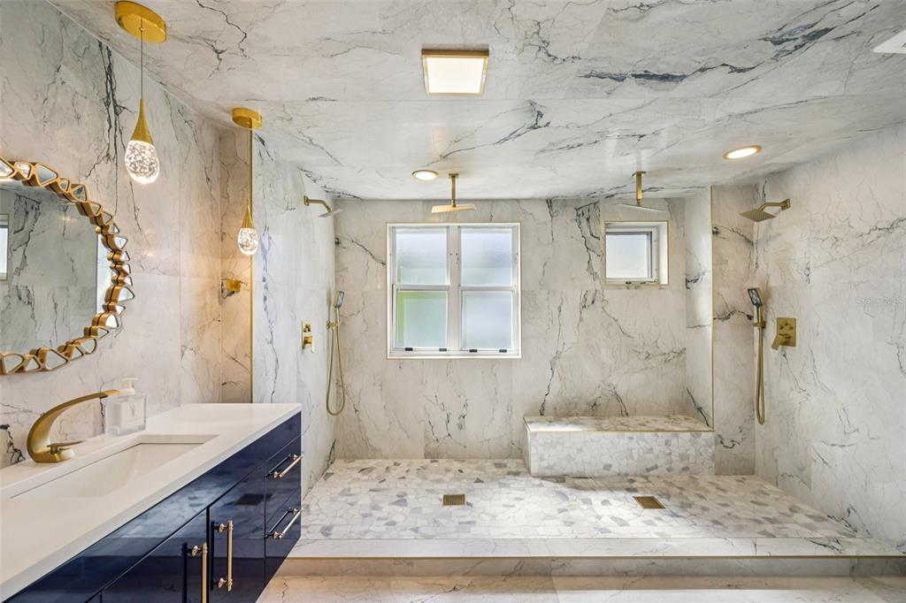 2450 Harbourside Drive, Unit 244 Longboat Key, FL 34228 - Photo 19 of 46 a bathroom with a sink a vanity a mirror and shower
