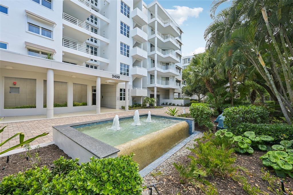 2450 Harbourside Drive, Unit 244 Longboat Key, FL 34228 - Photo 2 of 46 a view of a building with garden