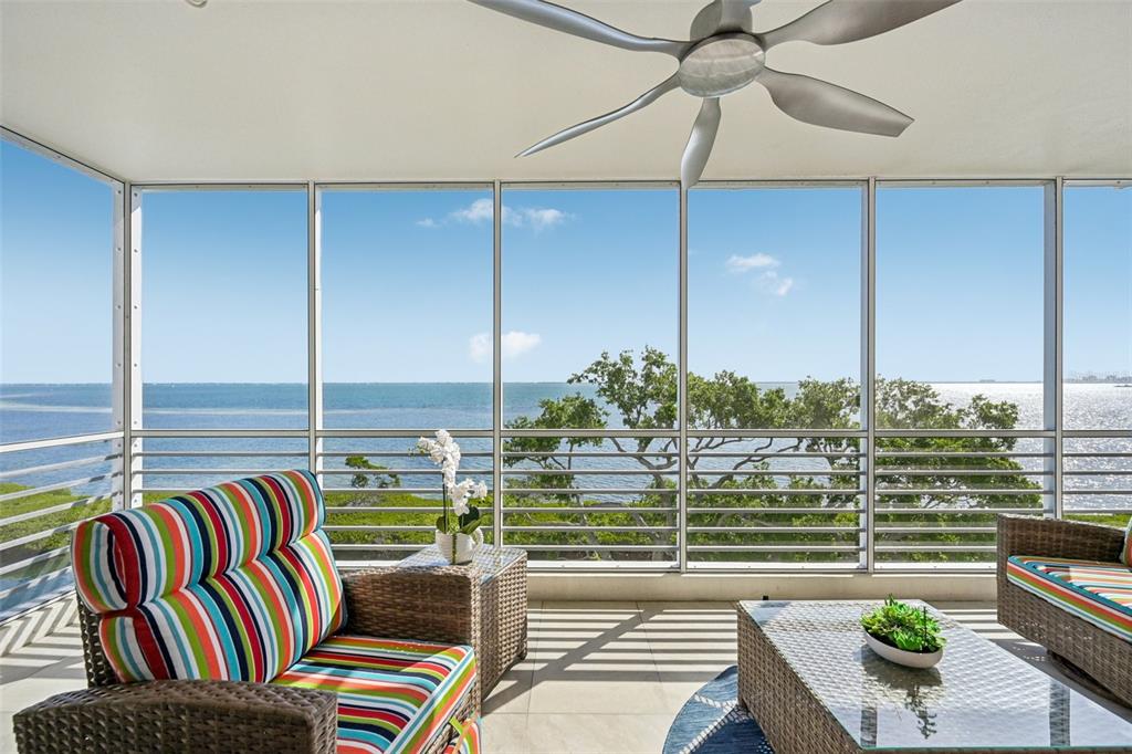 2450 Harbourside Drive, Unit 244 Longboat Key, FL 34228 - Photo 26 of 46 a living room with couches a flat screen tv and chandelier