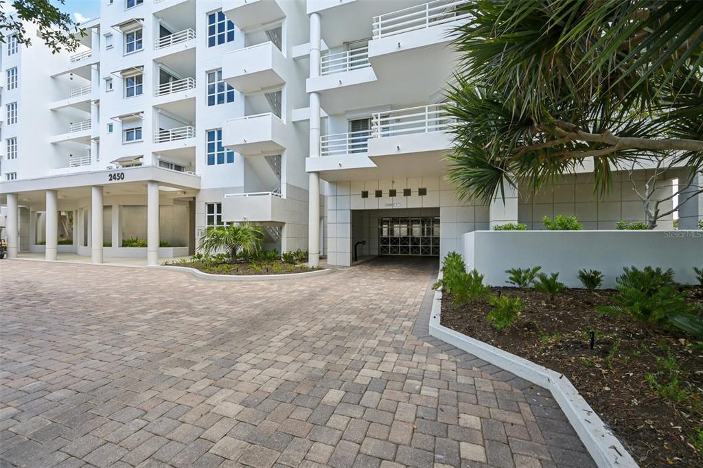 2450 Harbourside Drive, Unit 244 Longboat Key, FL 34228 - Photo 28 of 46 a front view of building with yard and green space