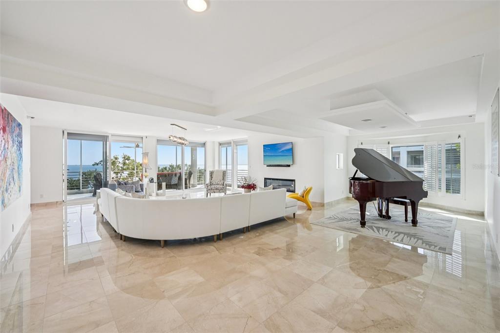 2450 Harbourside Drive, Unit 244 Longboat Key, FL 34228 - Photo 3 of 46 a living room with furniture and a table