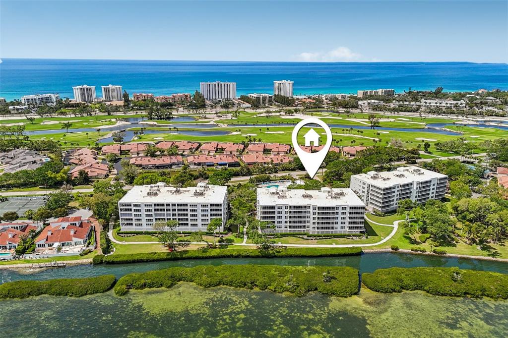2450 Harbourside Drive, Unit 244 Longboat Key, FL 34228 - Photo 34 of 46 a view of swimming pool with a garden and trees