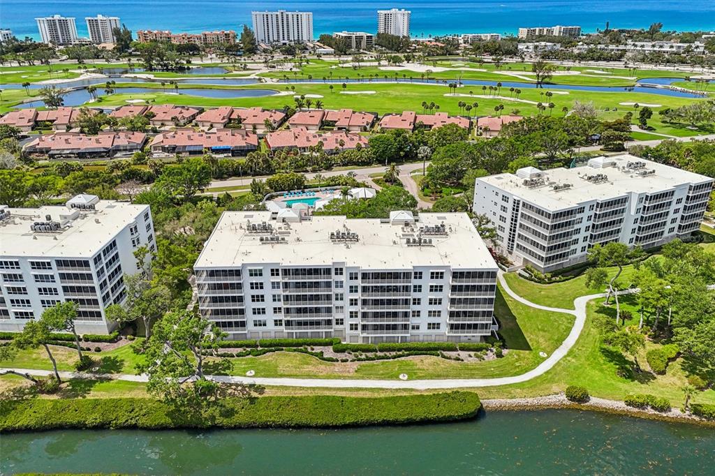 2450 Harbourside Drive, Unit 244 Longboat Key, FL 34228 - Photo 36 of 46 a view of a swimming pool and a yard