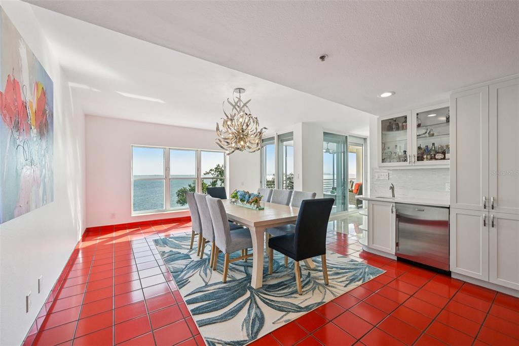 2450 Harbourside Drive, Unit 244 Longboat Key, FL 34228 - Photo 6 of 46 a dining room with furniture a chandelier and wooden floor
