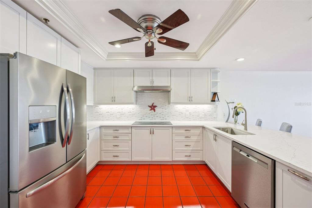 2450 Harbourside Drive, Unit 244 Longboat Key, FL 34228 - Photo 7 of 46 a large kitchen with cabinets a sink and stainless steel appliances