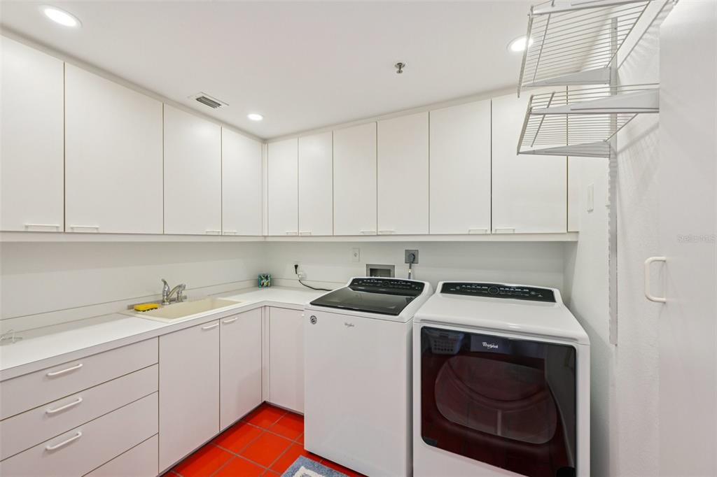 2450 Harbourside Drive, Unit 244 Longboat Key, FL 34228 - Photo 9 of 46 a utility room with sink dryer and washer