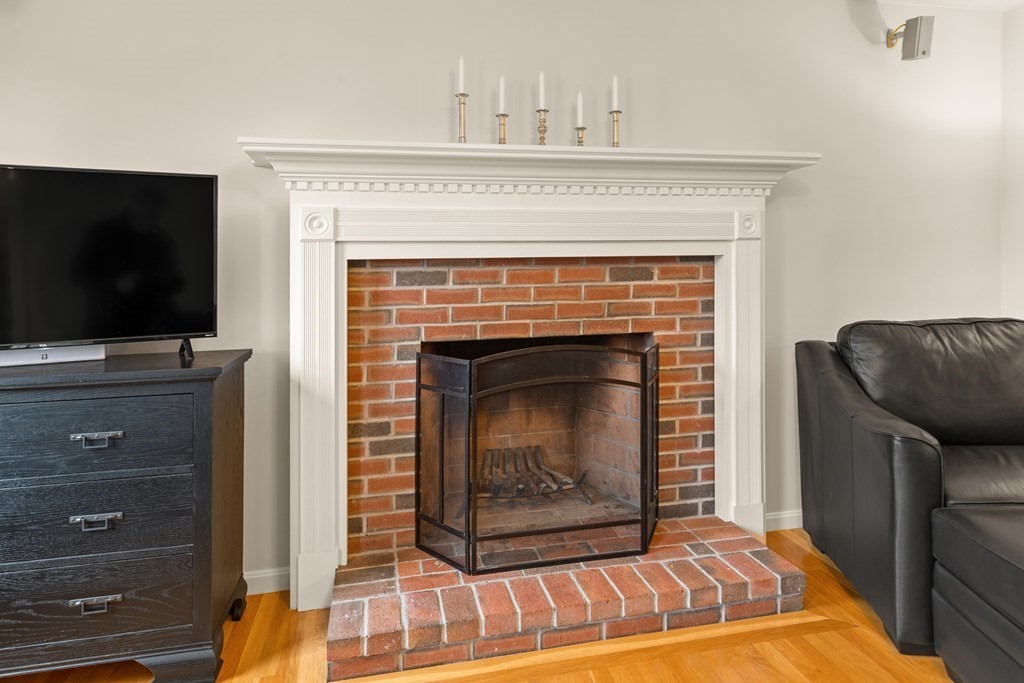 246 Morgan Road Whitinsville, MA 01588 - Photo 12 of 28 a living room with a fireplace and a television