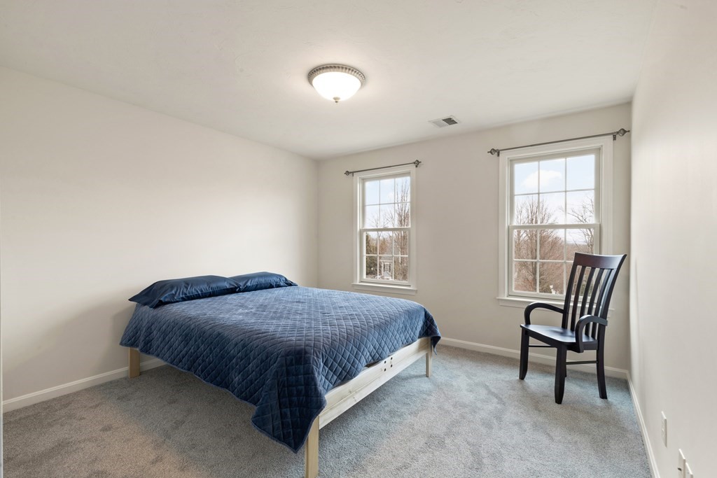 246 Morgan Road Whitinsville, MA 01588 - Photo 19 of 28 a bedroom with a bed chair and two large window