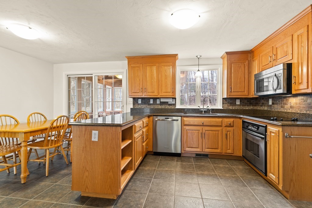 246 Morgan Road Whitinsville, MA 01588 - Photo 10 of 28 a kitchen with stainless steel appliances granite countertop a stove a sink and a microwave