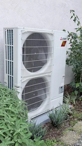 a view of a house with a window and flower plants