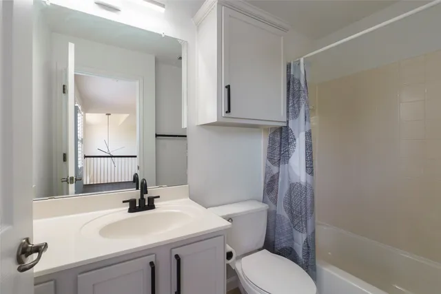 a bathroom with a sink toilet and mirror