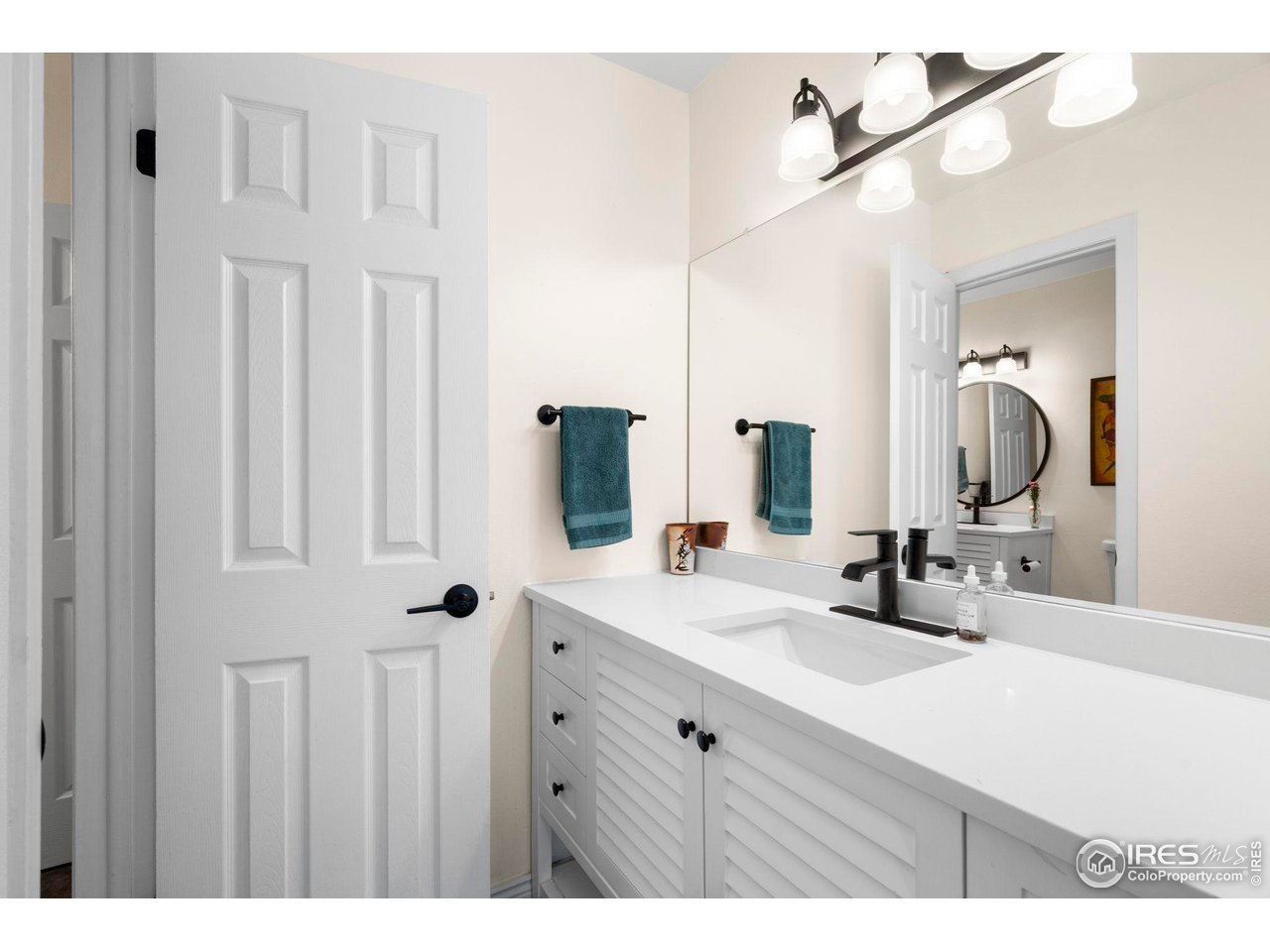 3878 Broadway, Unit 1 Boulder, CO 80304 - Photo 17 of 36 a bathroom with a double vanity sink and a mirror