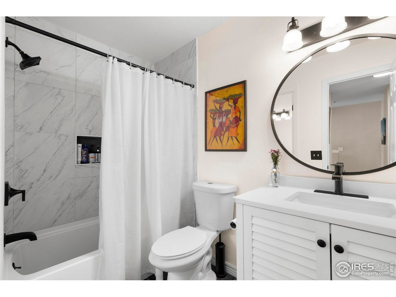 3878 Broadway, Unit 1 Boulder, CO 80304 - Photo 18 of 36 a bathroom with a sink a mirror a toilet and a shower