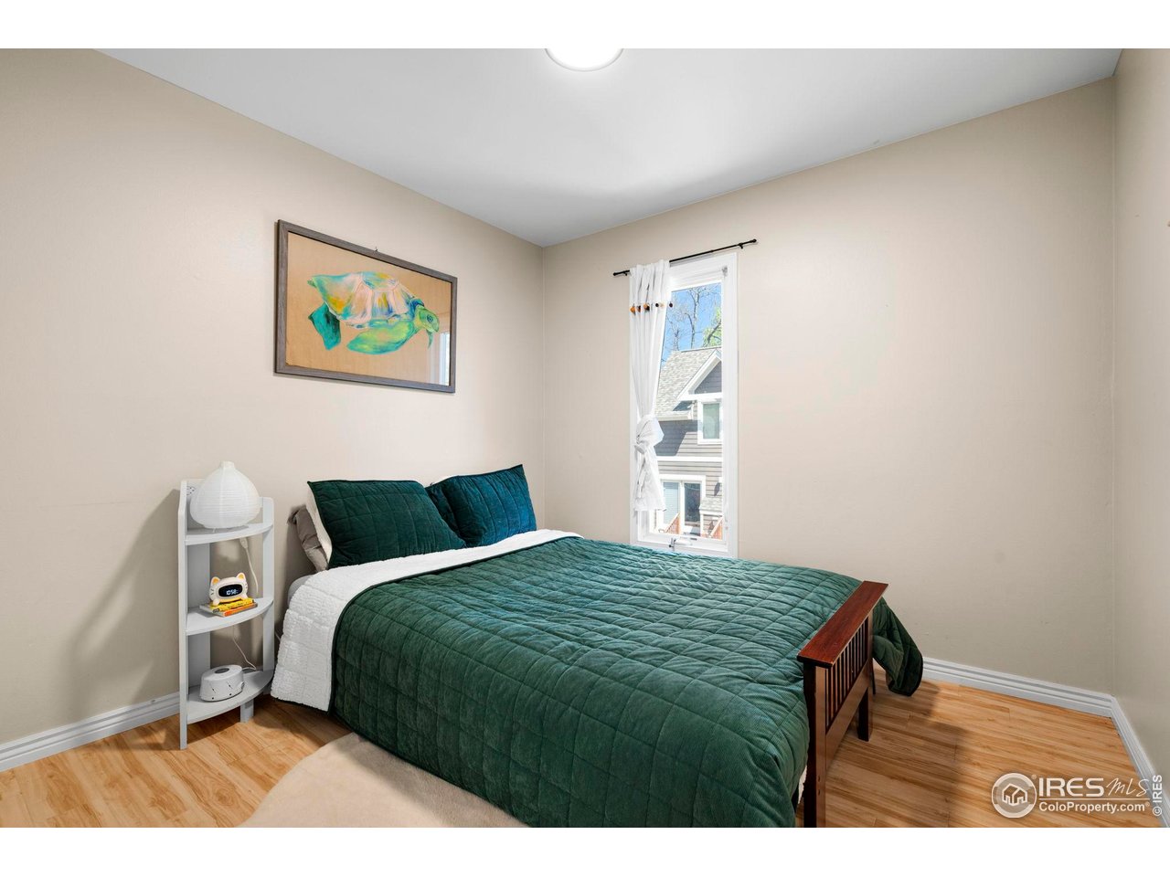 3878 Broadway, Unit 1 Boulder, CO 80304 - Photo 20 of 36 a bedroom with a bed and painting on the wall