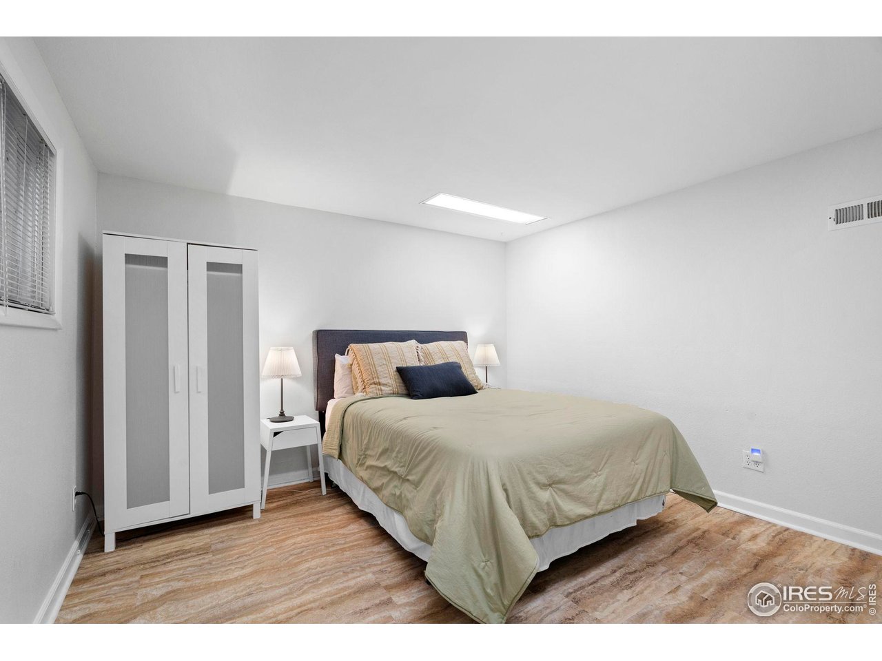 3878 Broadway, Unit 1 Boulder, CO 80304 - Photo 22 of 36 a bedroom with a bed and a night stand