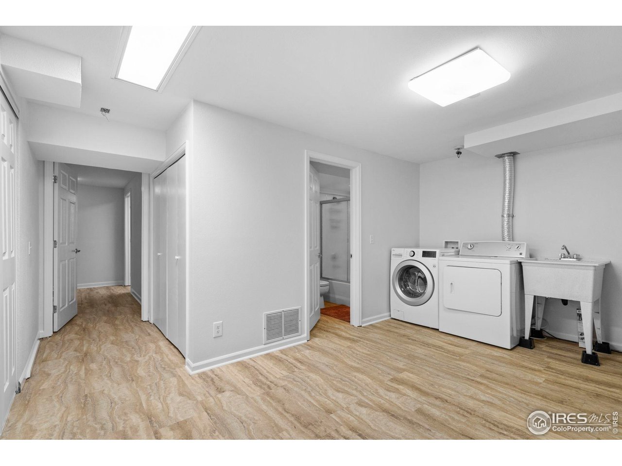 3878 Broadway, Unit 1 Boulder, CO 80304 - Photo 25 of 36 a hall with kitchen island a stove a wooden floors and white walls