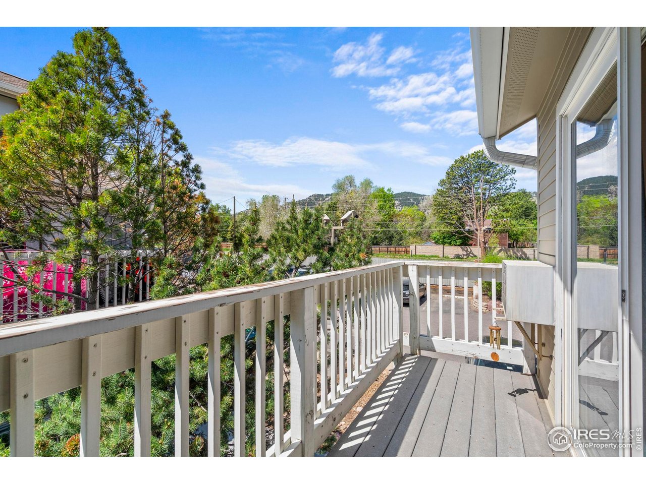 3878 Broadway, Unit 1 Boulder, CO 80304 - Photo 26 of 36 a view of balcony with wooden floor and fence