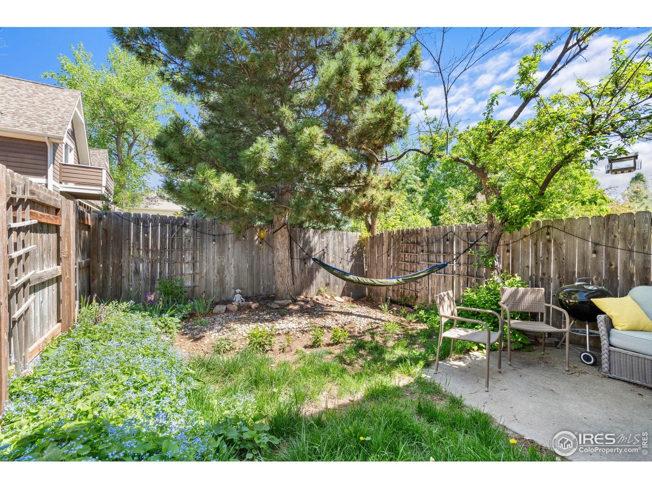 3878 Broadway, Unit 1 Boulder, CO 80304 - Photo 29 of 36 a backyard of a house with table and chairs