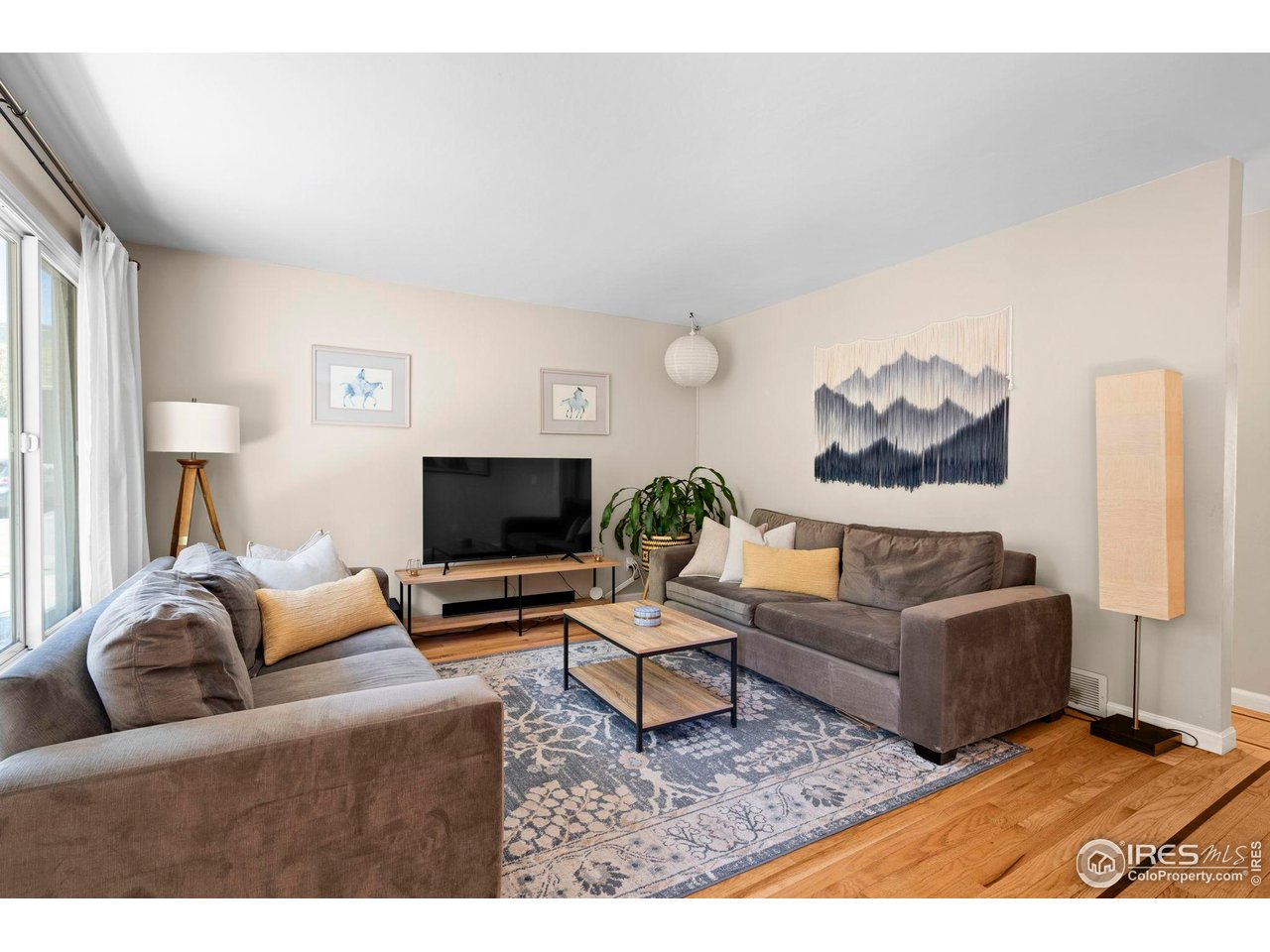 3878 Broadway, Unit 1 Boulder, CO 80304 - Photo 3 of 36 a living room with furniture and a flat screen tv