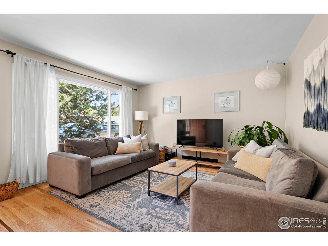3878 Broadway, Unit 1 Boulder, CO 80304 - Photo 4 of 36 a living room with furniture and a flat screen tv